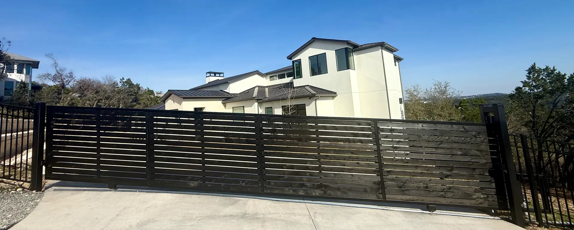 Modern horizontal-slat automatic driveway gate installed in Austin, TX