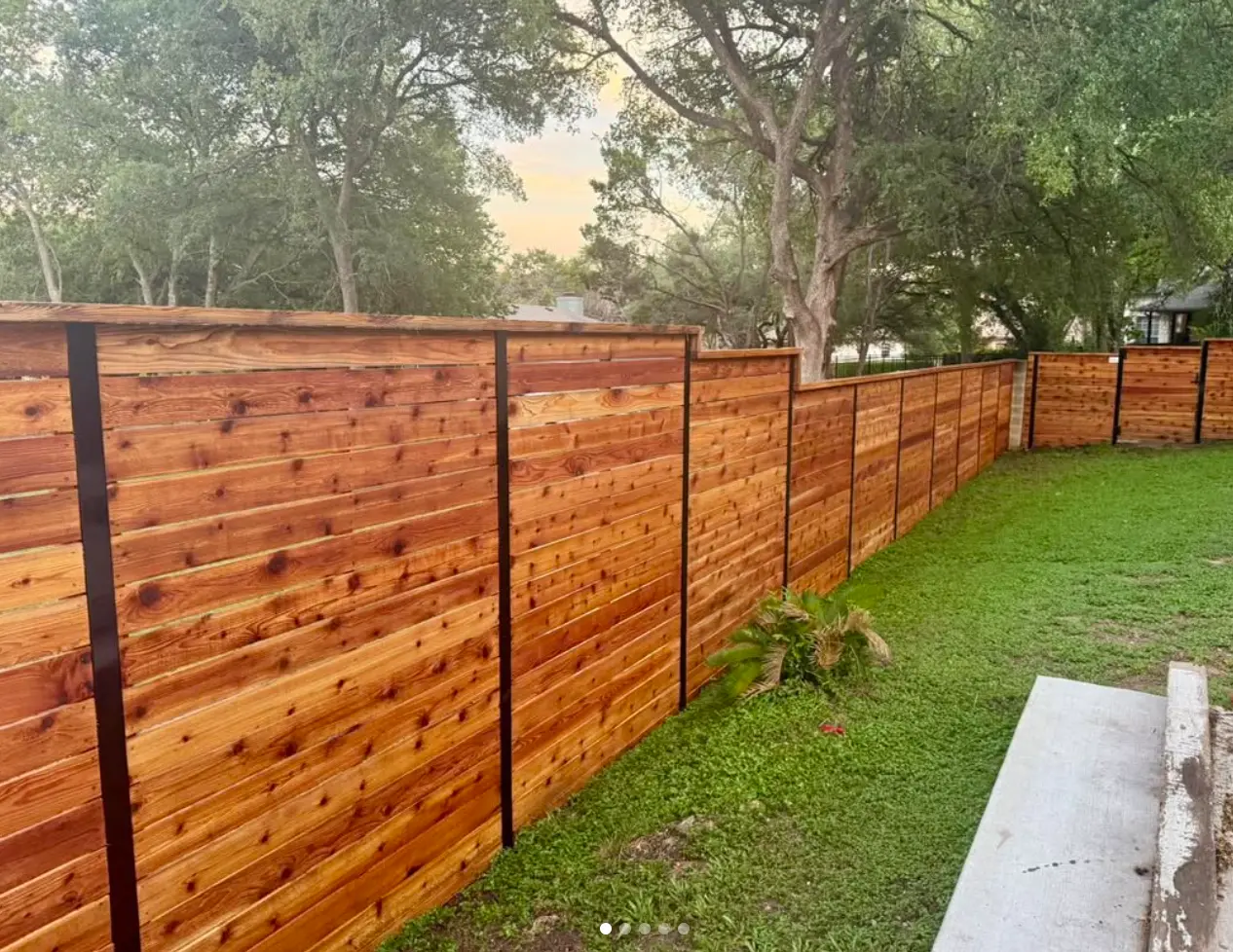 Horizontal stained cedar privacy fence with cap rail in Austin, TX